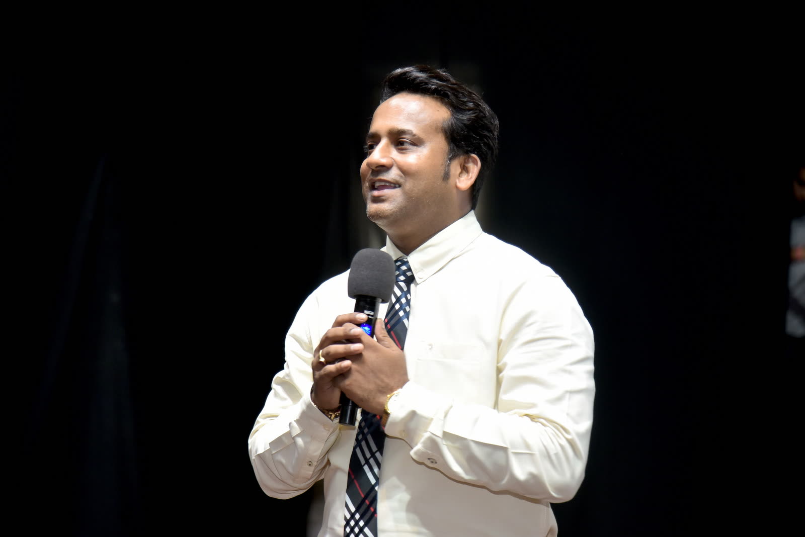 Manoj Chauhan on stage with microphone